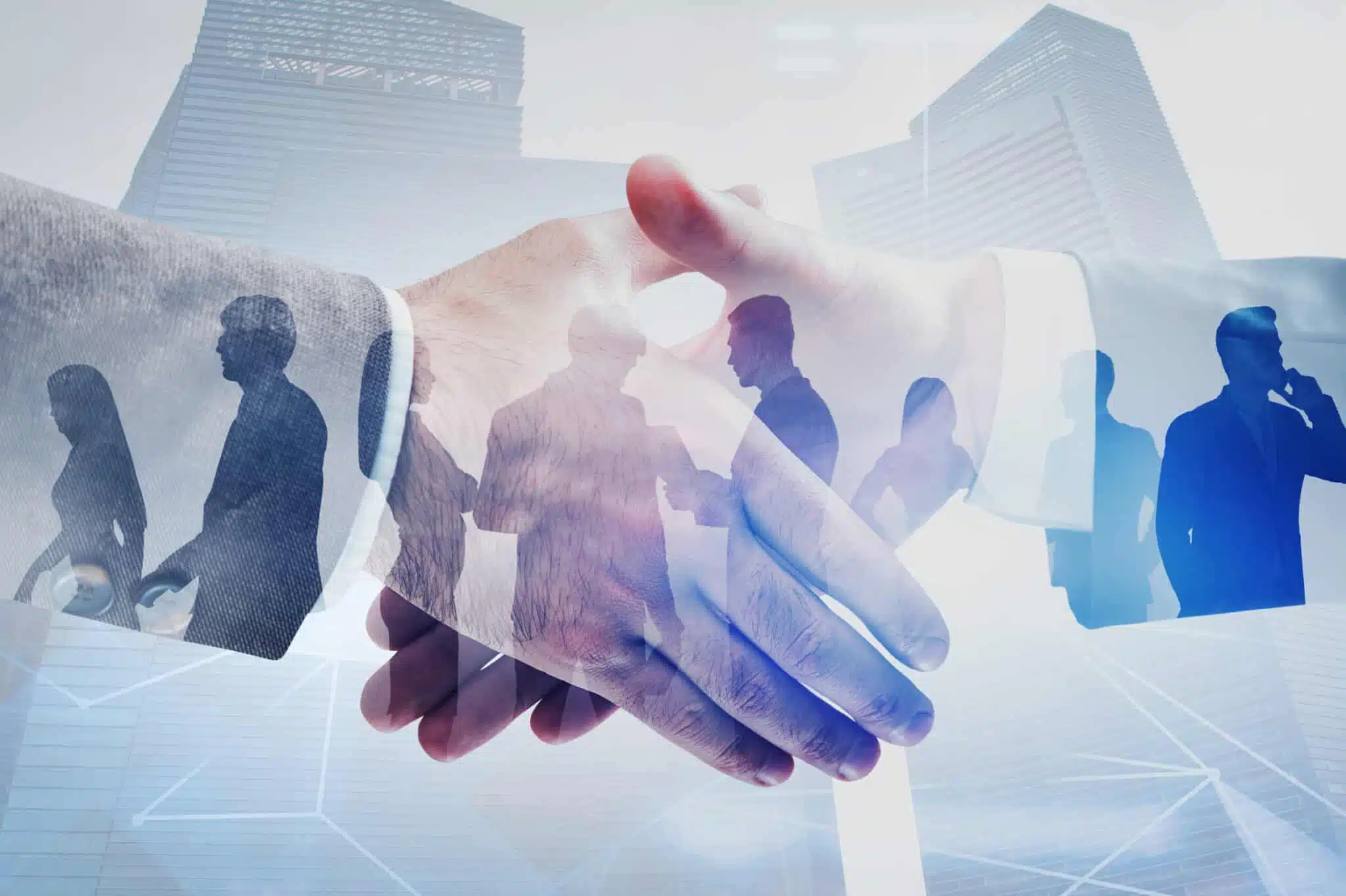 Close,Up,Of,Two,Businessmen,Shaking,Hands,In,Modern,City